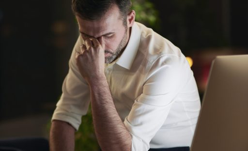 Tired businessman suffering from headache