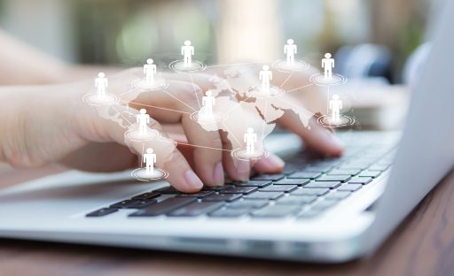 Closeup of business woman hand typing on laptop keyboard
